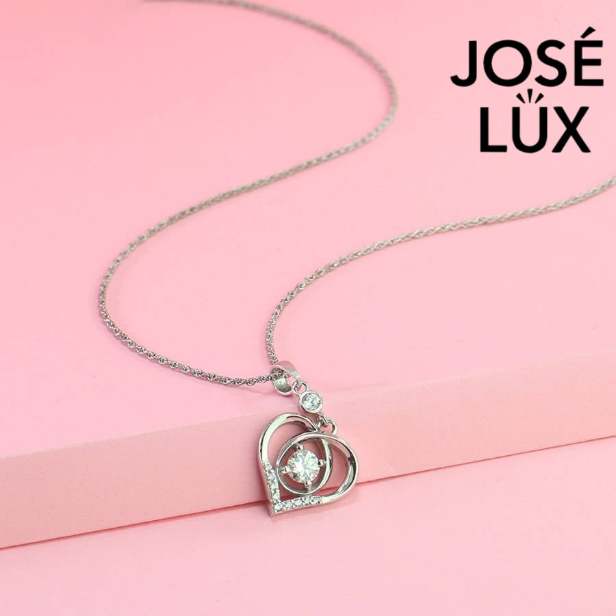 Heartfelt 0.5ct round moissanite dancing heart pendant features floating center stone within layered heart design, tenderly crafted in polished sterling silver