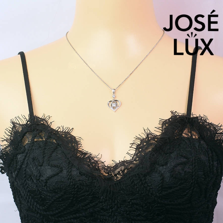 Heartfelt 0.5ct round moissanite dancing heart pendant features floating center stone within layered heart design, tenderly crafted in polished sterling silver