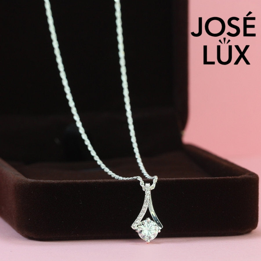 Sleek 0.8ct round moissanite angular frame pendant showcases modern geometric design with pavé-accented linear elements, expertly constructed in premium sterling silver.