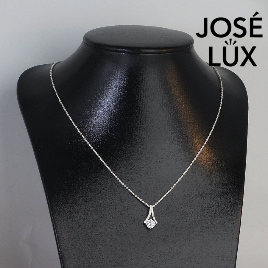 Sleek 0.8ct round moissanite angular frame pendant showcases modern geometric design with pavé-accented linear elements, expertly constructed in premium sterling silver.