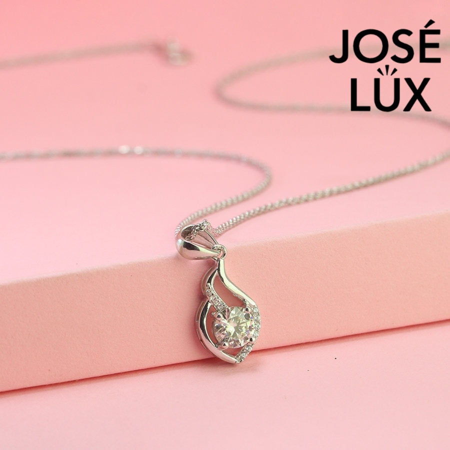 Graceful 0.8ct round moissanite flame swirl pendant features flowing curved design with pavé accents, creating dynamic movement in quality sterling silver craftsmanship.