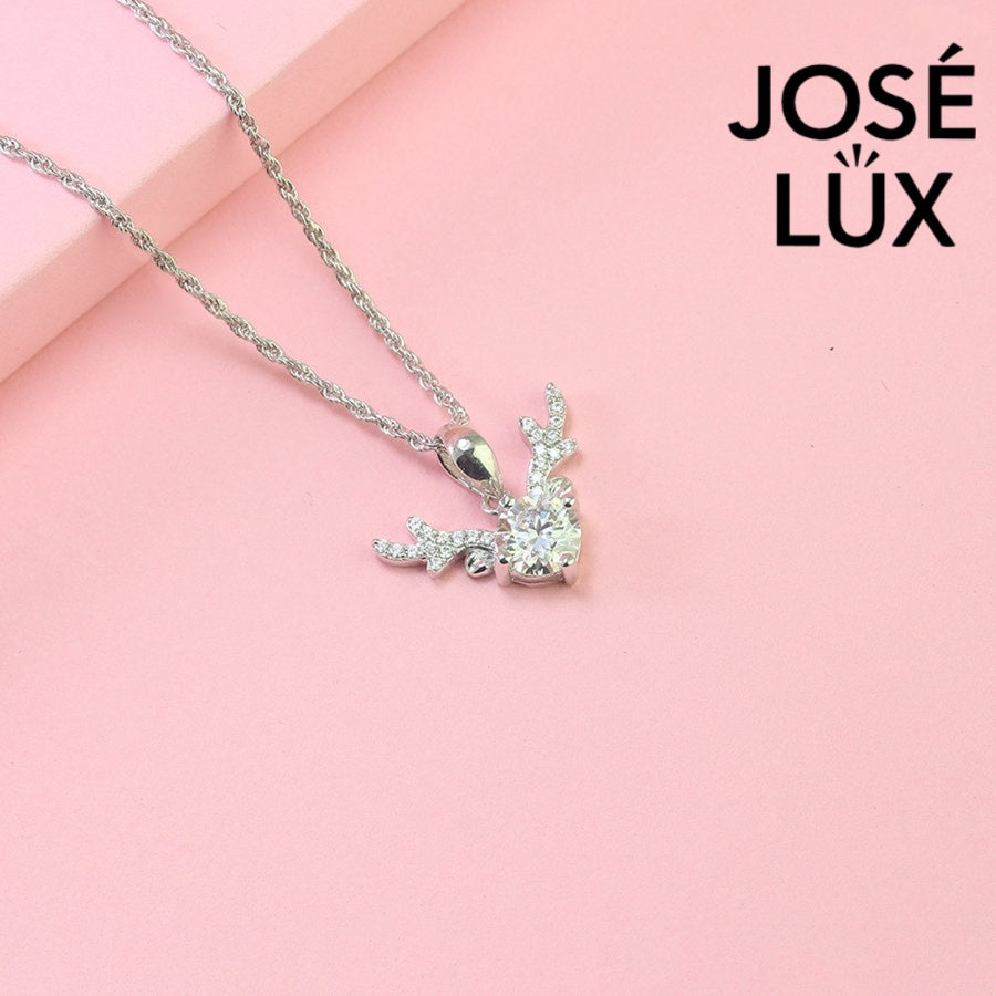 Enchanting 0.8ct round moissanite reindeer antler pendant features brilliant center stone with pavé-set antler details, capturing woodland magic in sterling silver.