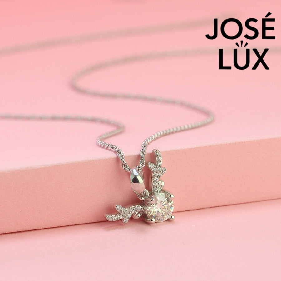 Enchanting 0.8ct round moissanite reindeer antler pendant features brilliant center stone with pavé-set antler details, capturing woodland magic in sterling silver.