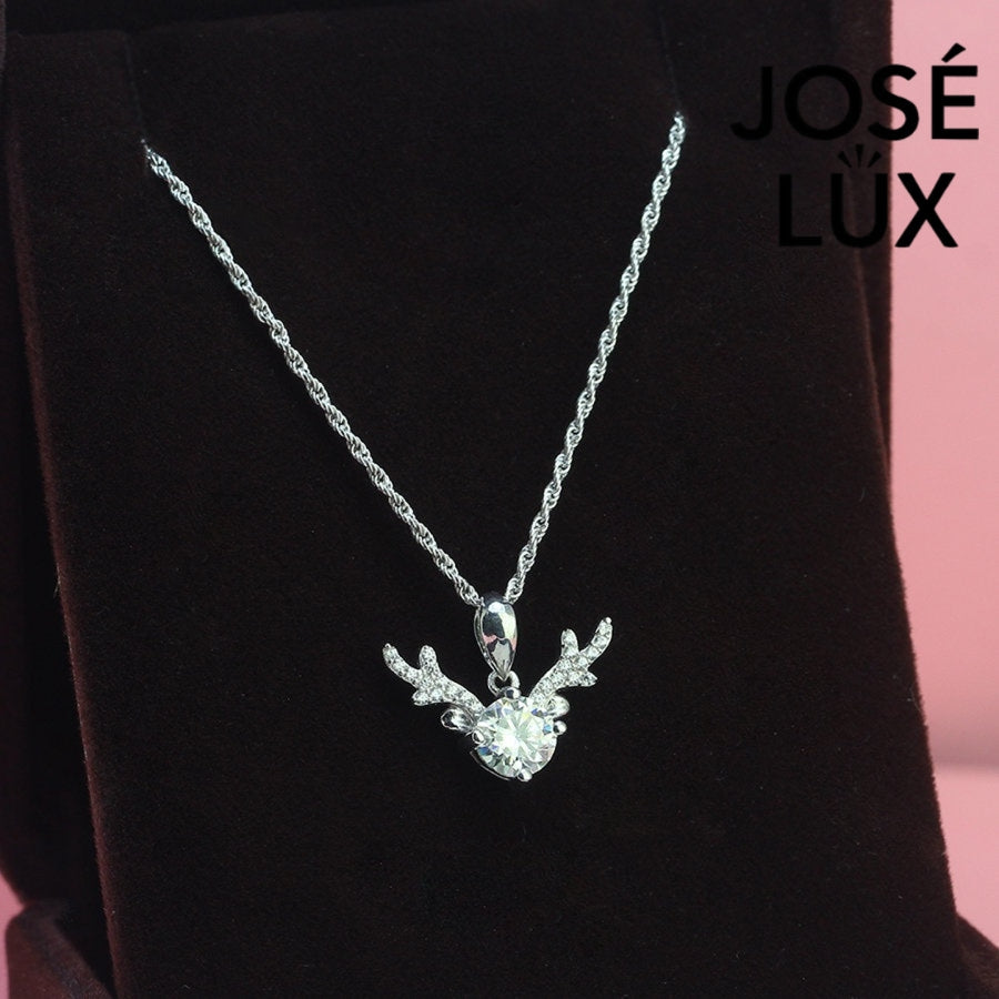 Enchanting 0.8ct round moissanite reindeer antler pendant features brilliant center stone with pavé-set antler details, capturing woodland magic in sterling silver.