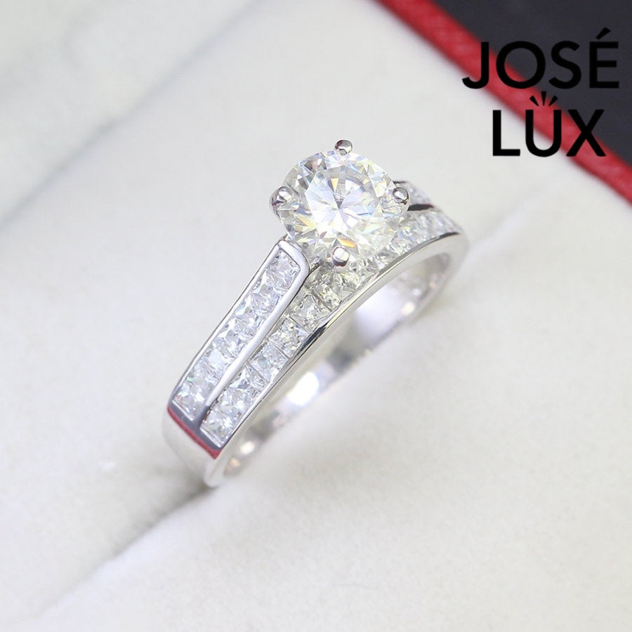 Stunning harmony set includes 1.25ct moissanite engagement ring with matching channel-set wedding band, beautifully crafted in sterling silver.