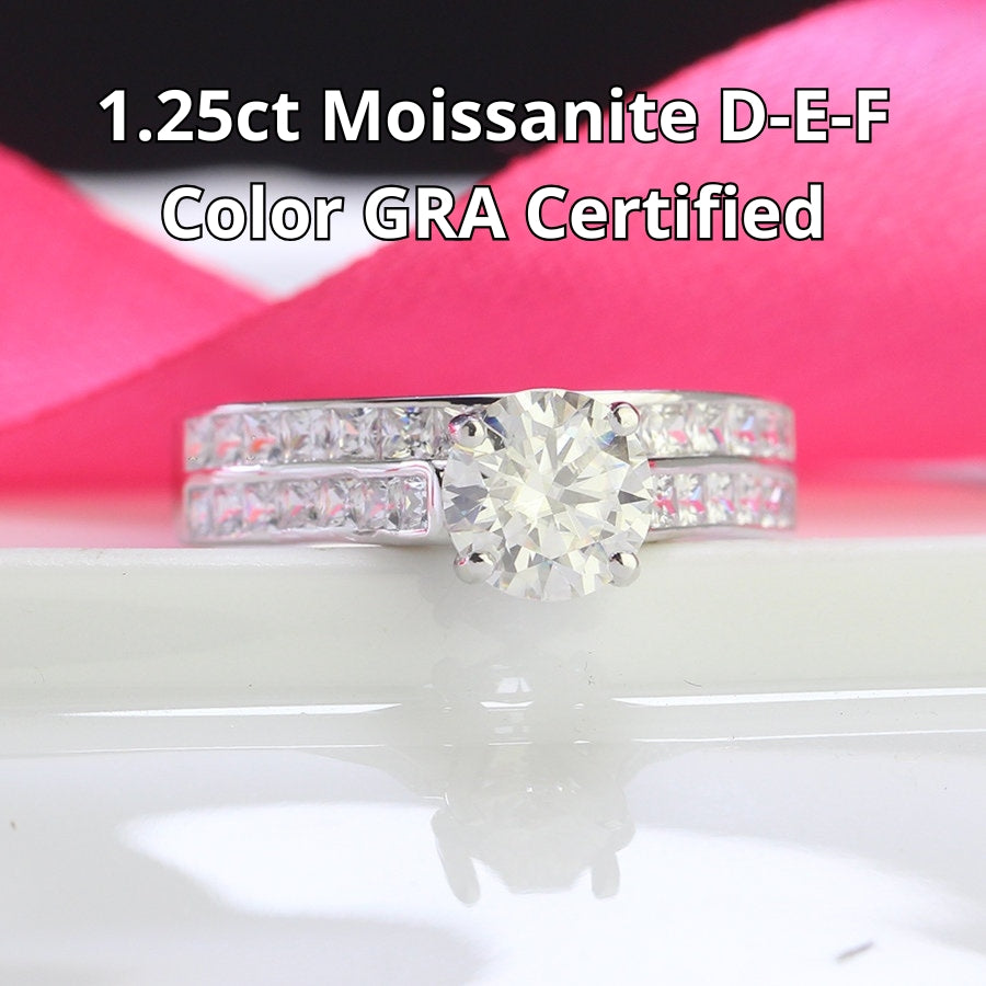 Stunning harmony set includes 1.25ct moissanite engagement ring with matching channel-set wedding band, beautifully crafted in sterling silver.
