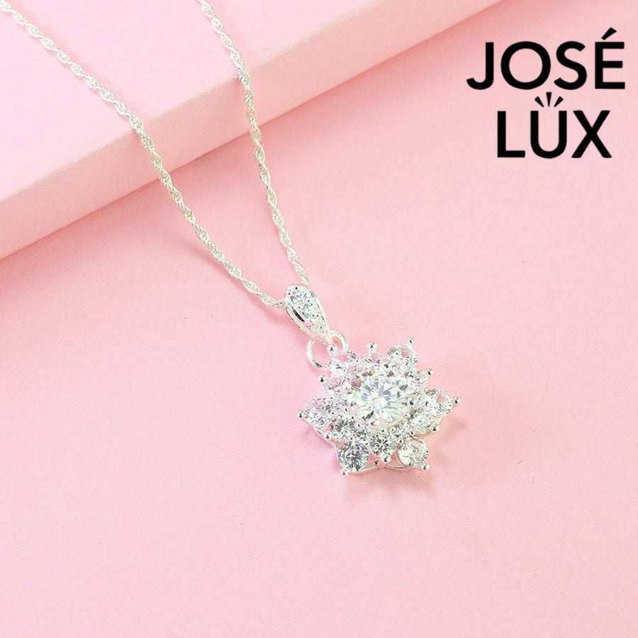 Dazzling 1.2ct moissanite star cluster pendant features brilliant center stone surrounded by radiating accents, creating captivating sparkle in fine sterling silver craftsmanship.