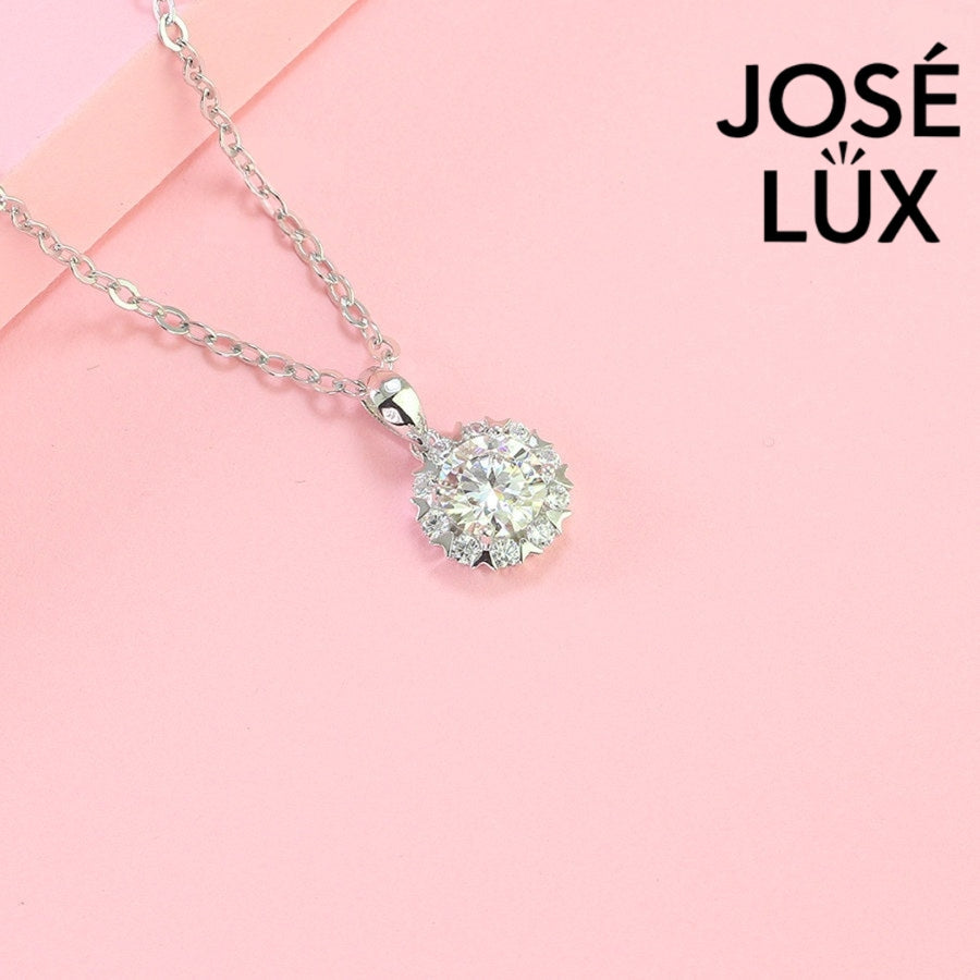 Romantic 1.2ct round moissanite heart halo pendant showcases brilliant center stone within pavé-set heart frame, lovingly handcrafted in gleaming sterling silver.