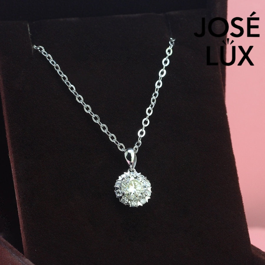 Romantic 1.2ct round moissanite heart halo pendant showcases brilliant center stone within pavé-set heart frame, lovingly handcrafted in gleaming sterling silver.