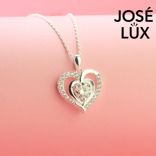 Romantic 1.2ct round moissanite heart halo pendant showcases brilliant center stone within pavé-set heart frame, lovingly handcrafted in gleaming sterling silver.