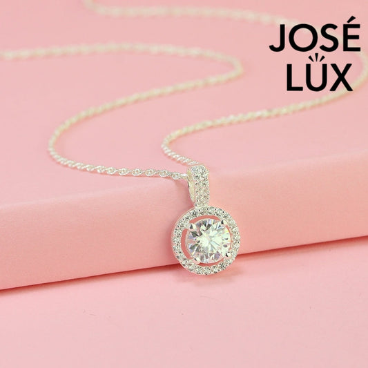 Luxurious 1.2ct round moissanite pavé bail halo pendant displays maximum sparkle with stone-set connector and surrounding halo, skillfully set in sterling silver.