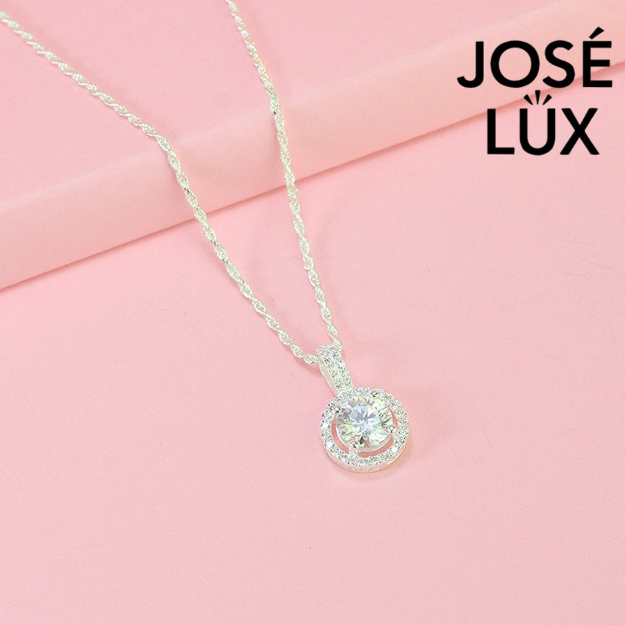 Luxurious 1.2ct round moissanite pavé bail halo pendant displays maximum sparkle with stone-set connector and surrounding halo, skillfully set in sterling silver.