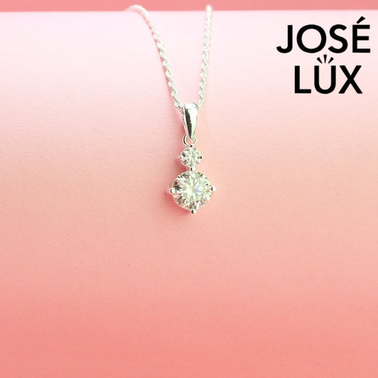 Refined 1.2ct two stone round moissanite drop pendant showcases graduated brilliance with dual stones in vertical arrangement, precisely crafted in sterling silver.