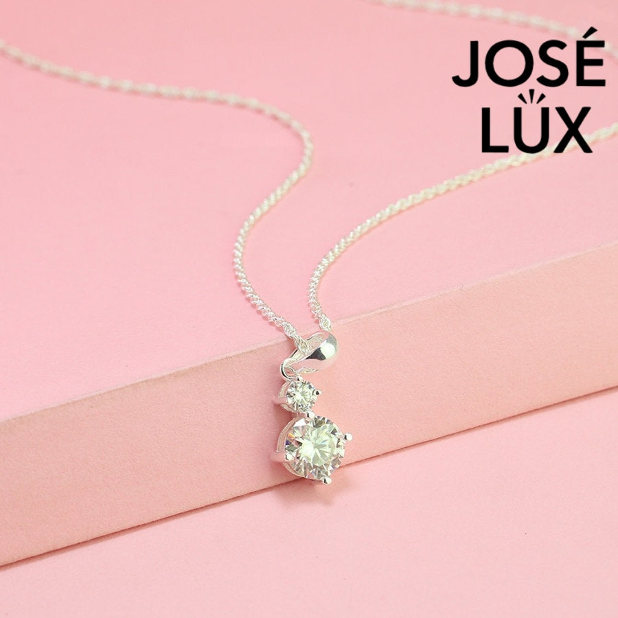 Refined 1.2ct two stone round moissanite drop pendant showcases graduated brilliance with dual stones in vertical arrangement, precisely crafted in sterling silver.