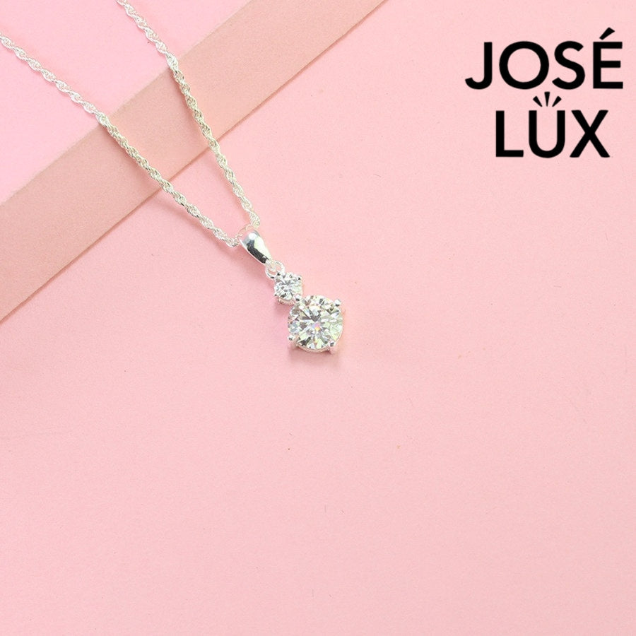 Refined 1.2ct two stone round moissanite drop pendant showcases graduated brilliance with dual stones in vertical arrangement, precisely crafted in sterling silver.