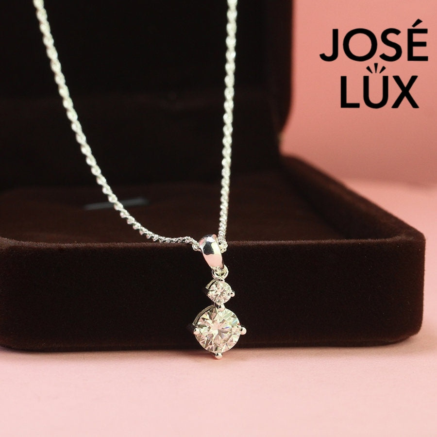 Refined 1.2ct two stone round moissanite drop pendant showcases graduated brilliance with dual stones in vertical arrangement, precisely crafted in sterling silver.