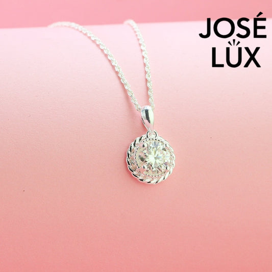 Elegant 1.5ct round moissanite pendant features distinctive twisted rope bezel setting, combining vintage charm with brilliant sparkle in quality sterling silver.