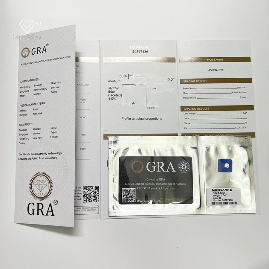 Stunning sunburst design features brilliant round moissanite surrounded by baguette and round accent stones with sparkling pavé band detailing.