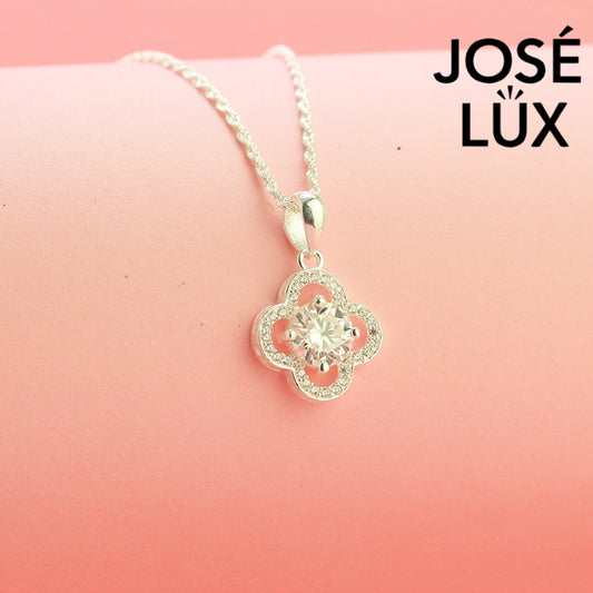 Lucky 1ct round moissanite clover halo pendant symbolizes good fortune with pavé-accented quatrefoil design, gracefully handcrafted in polished sterling silver.