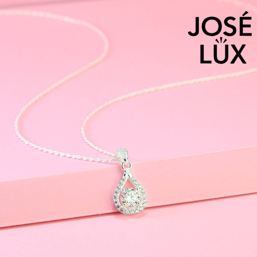 Contemporary 1ct round moissanite open teardrop halo pendant showcases brilliant center stone within elegant wishbone frame, beautifully designed in sterling silver.