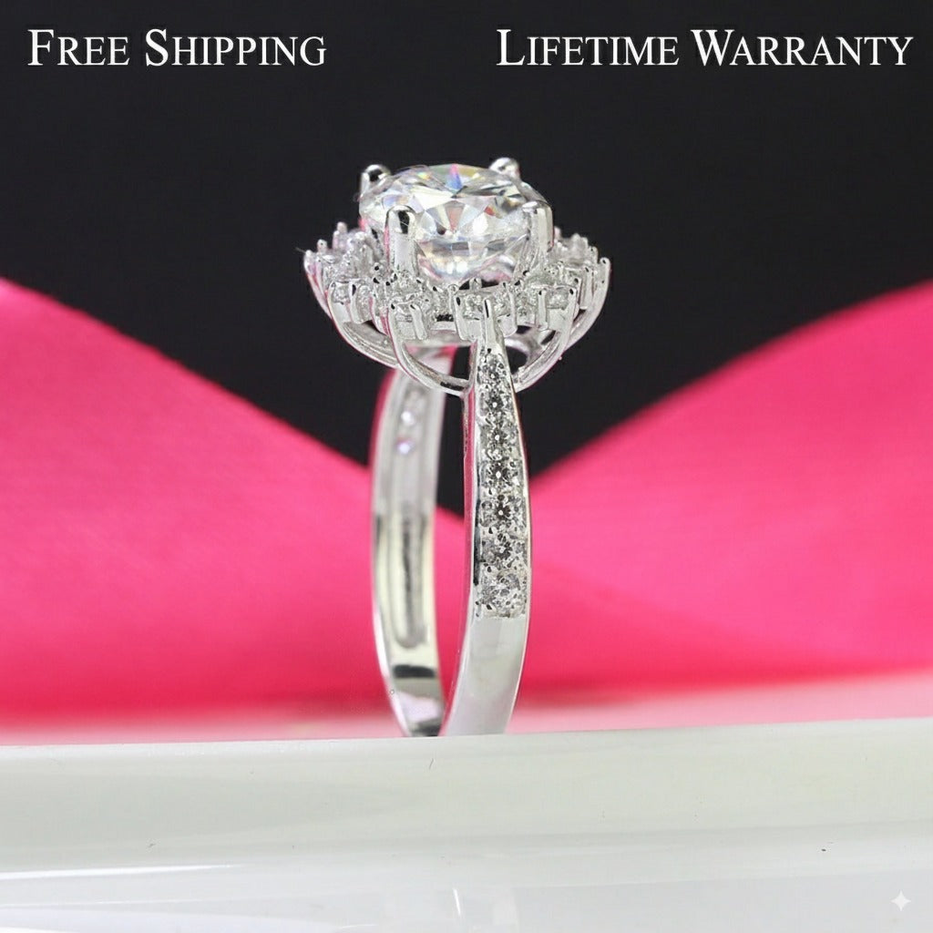 Elegant 2ct moissanite center stone surrounded by sparkling halo diamonds on a pavé silver band. Classic design perfect for special occasions and everyday elegance.