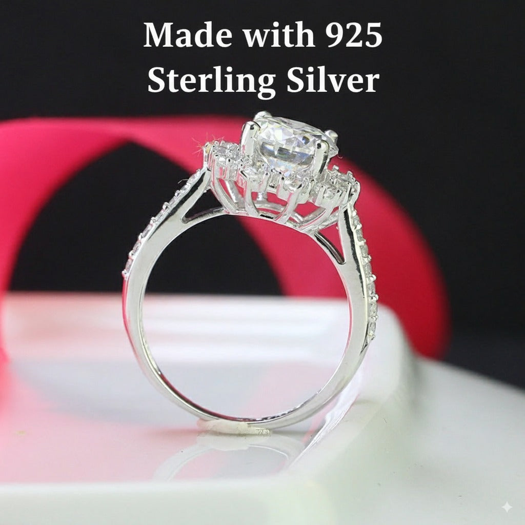 Elegant 2ct moissanite center stone surrounded by sparkling halo diamonds on a pavé silver band. Classic design perfect for special occasions and everyday elegance.