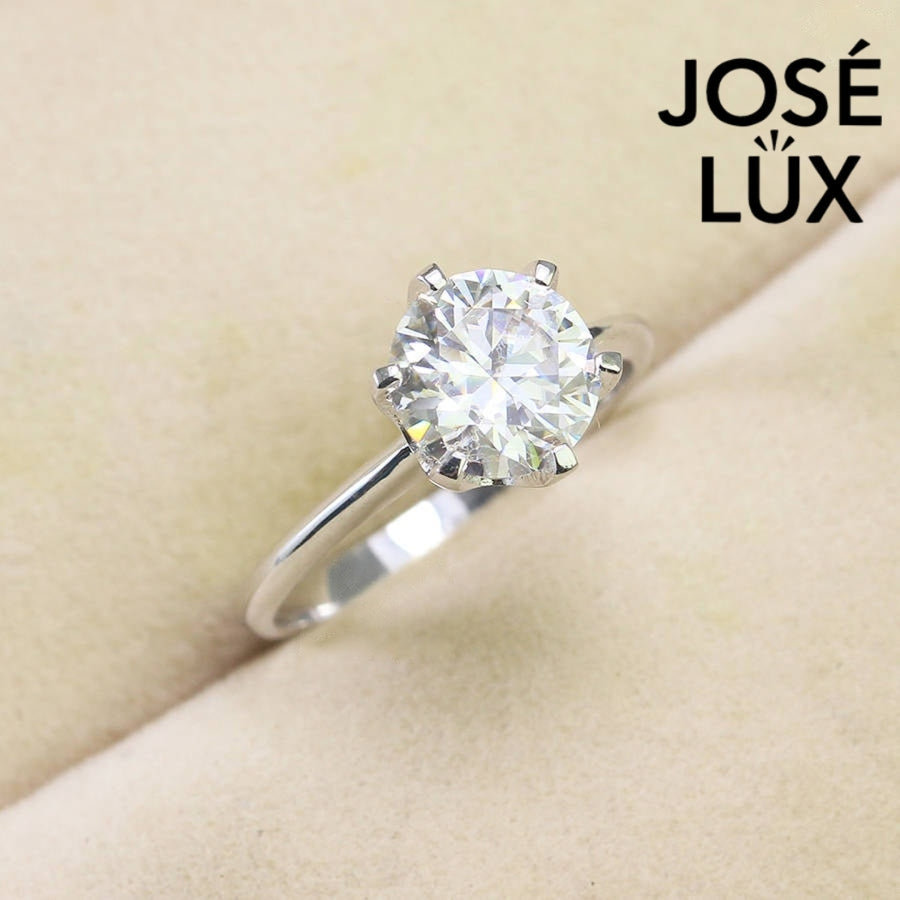 Timeless solitaire setting showcases brilliant round moissanite centerpiece on a sleek polished silver band for effortless everyday elegance.