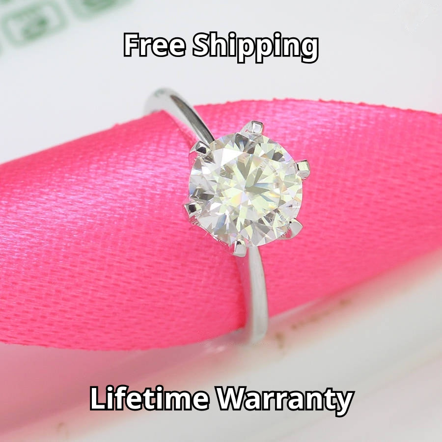 Timeless solitaire setting showcases brilliant round moissanite centerpiece on a sleek polished silver band for effortless everyday elegance.