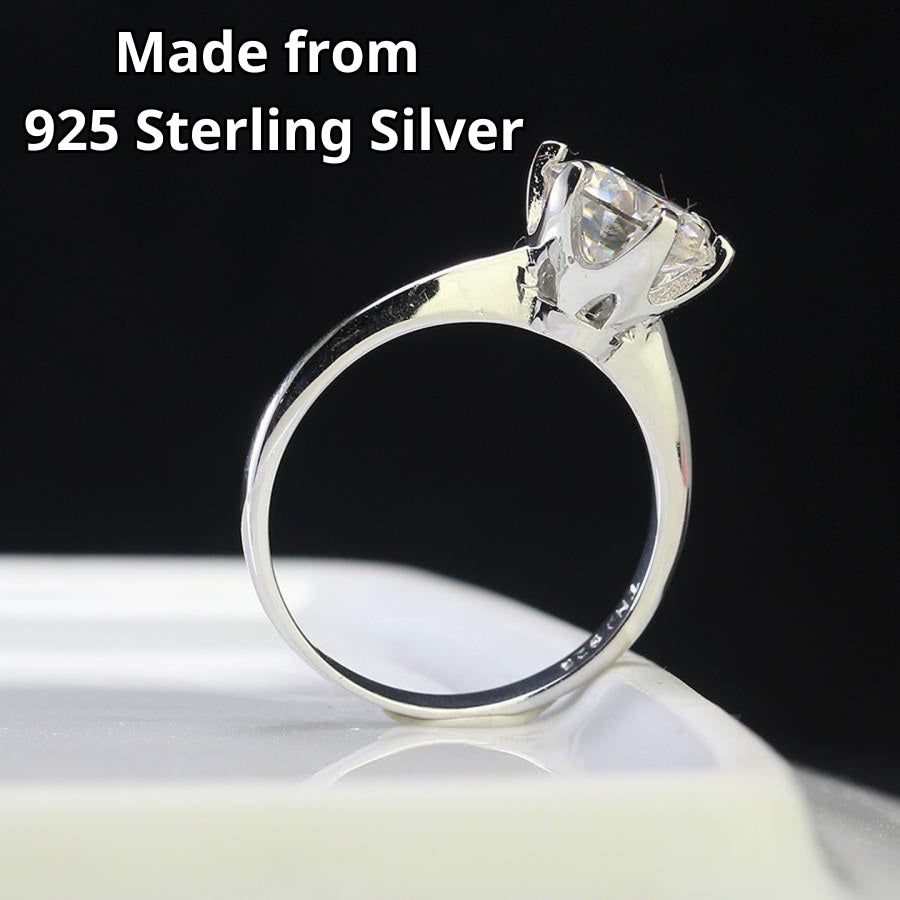 Timeless solitaire setting showcases brilliant round moissanite centerpiece on a sleek polished silver band for effortless everyday elegance.