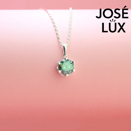 Stunning 2ct round green moissanite solitaire pendant offers vibrant color and exceptional brilliance in classic six-prong setting, beautifully set in sterling silver.