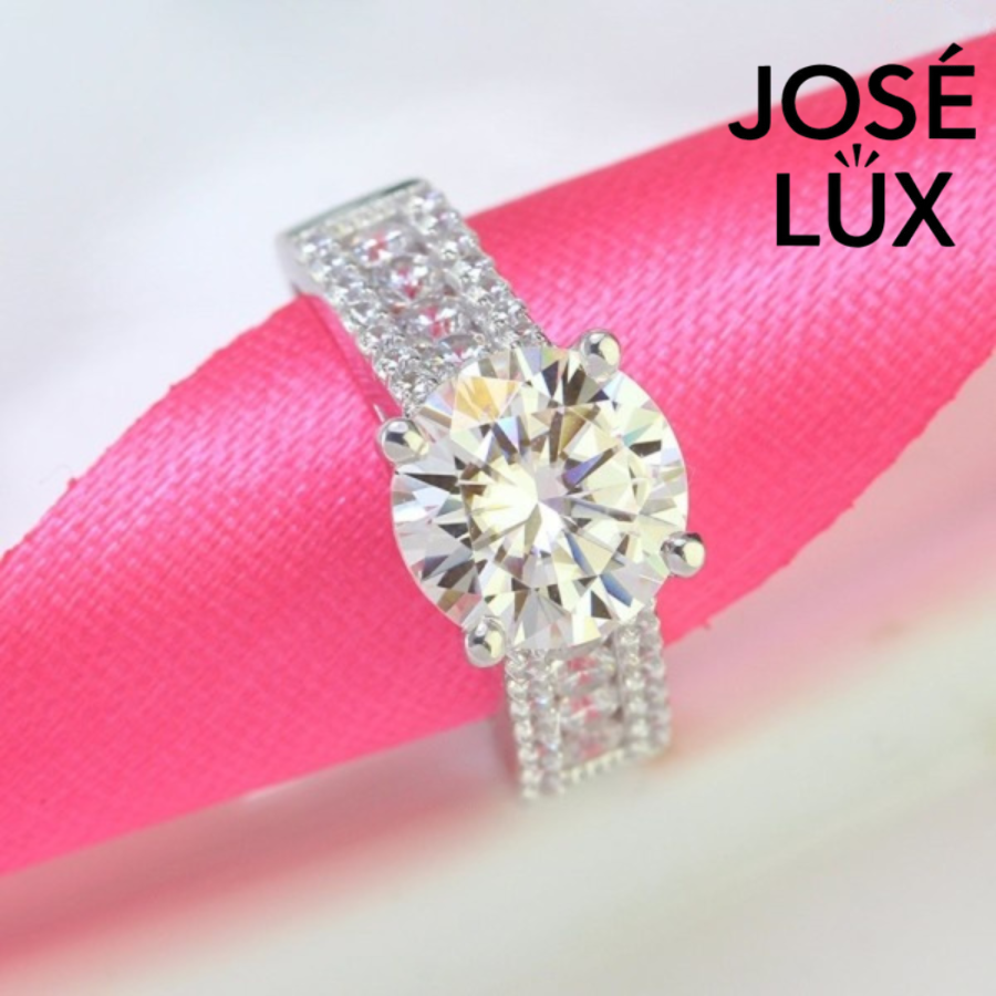 Brilliant 4ct round moissanite set in a sparkling pave band design. This sterling silver ring features exceptional fire and brilliance for everyday elegance.