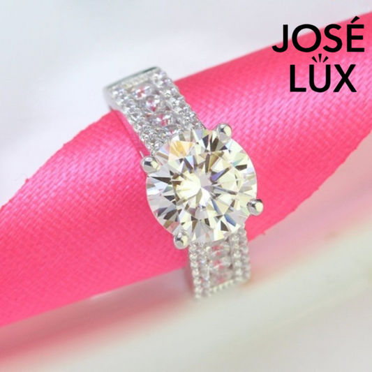 Brilliant 4ct round moissanite set in a sparkling pave band design. This sterling silver ring features exceptional fire and brilliance for everyday elegance.