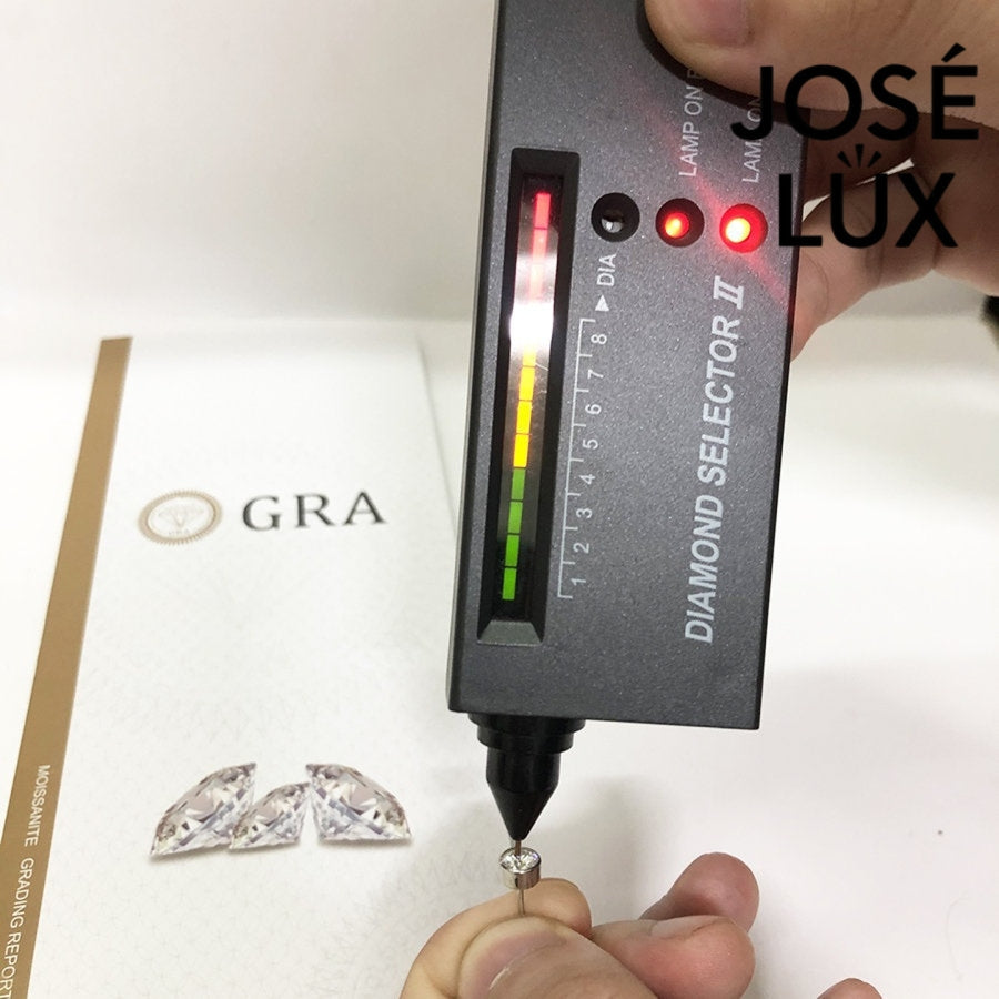 Moissanite stud earring being tested with diamond selector tool, confirming authenticity of 0.5ct GRA certified stone.