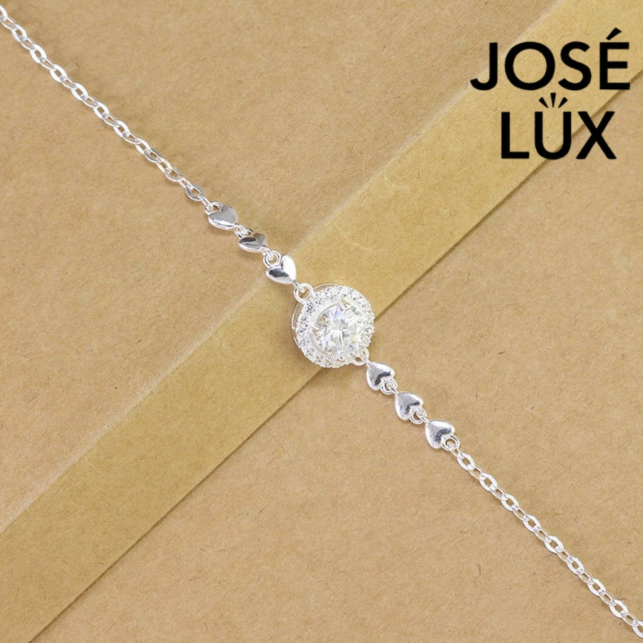 Cable chain halo moissanite bracelet in sterling silver features round brilliant centerpiece with heart accents weighing 1.0 carat on adjustable chain design.