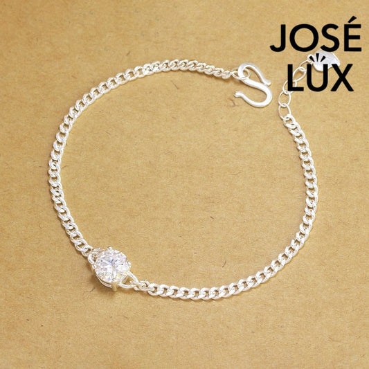 Sterling silver moissanite bracelet with curb link chain showcases brilliant solitaire stone weighing 1.0 carat featuring adjustable design and secure clasp closure.