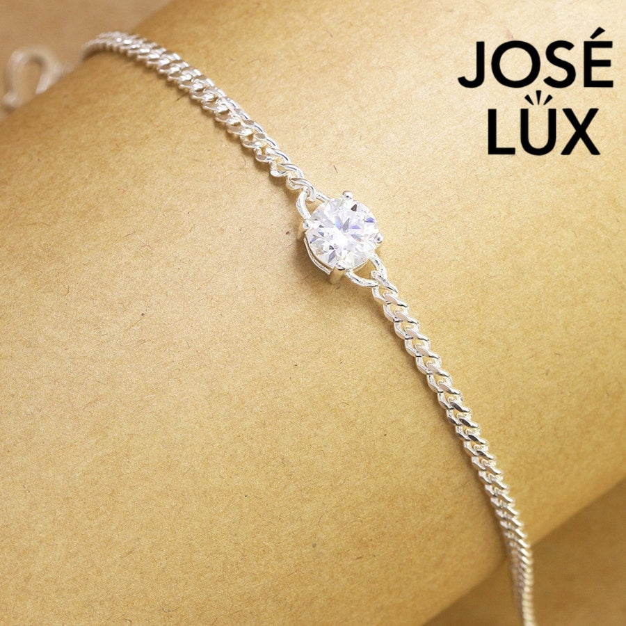 Sterling silver moissanite bracelet with curb link chain showcases brilliant solitaire stone weighing 1.0 carat featuring adjustable design and secure clasp closure.