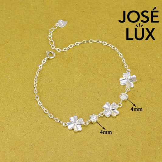Flower station cable moissanite bracelet in sterling silver features three botanical motifs with brilliant stones totaling 0.6 carats on adjustable chain design.