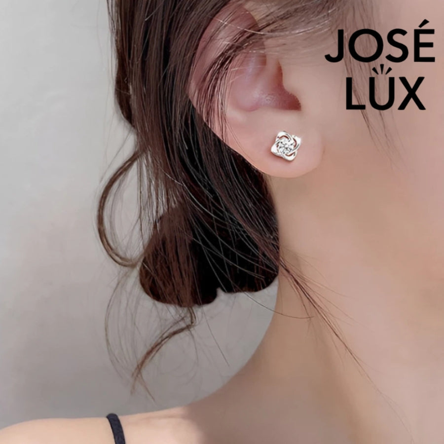 Brilliant moissanite stones set in elegant flower-shaped silver settings. These versatile stud earrings add sophisticated sparkle to any outfit, perfect for daily wear or special occasions.