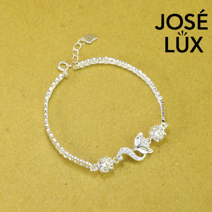 Fox charm tennis moissanite bracelet in sterling silver showcases charming animal centerpiece with two brilliant stones totaling 1.02 carats on classic chain.
