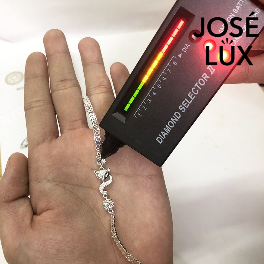 Fox charm tennis moissanite bracelet in sterling silver showcases charming animal centerpiece with two brilliant stones totaling 1.02 carats on classic chain.