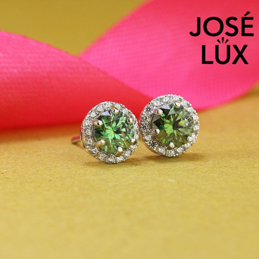 Stunning green moissanite with sparkling halo setting in sterling silver. Vibrant color and brilliant fire create captivating elegance for sophisticated everyday wear.