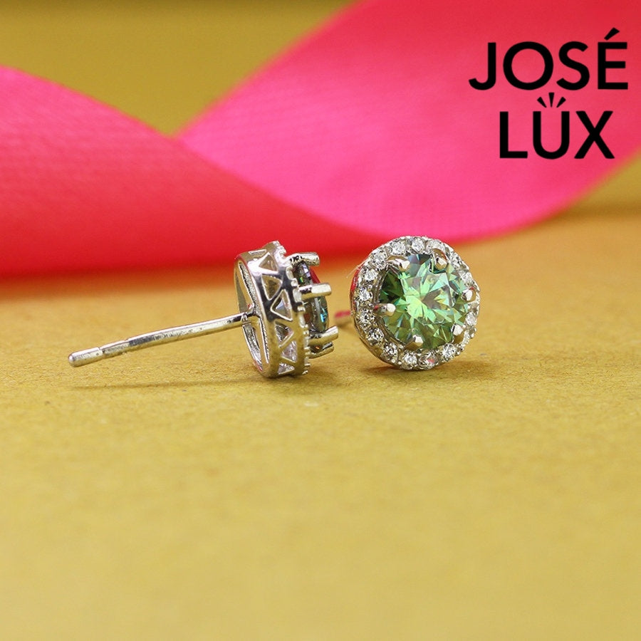 Stunning green moissanite with sparkling halo setting in sterling silver. Vibrant color and brilliant fire create captivating elegance for sophisticated everyday wear.