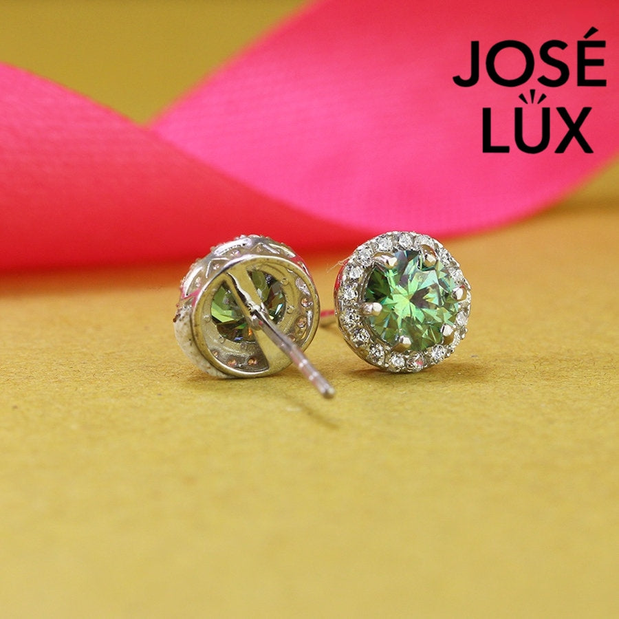 Stunning green moissanite with sparkling halo setting in sterling silver. Vibrant color and brilliant fire create captivating elegance for sophisticated everyday wear.
