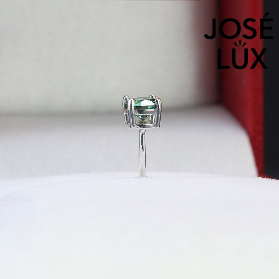 Sterling silver studs with 0.5ct vibrant green moissanite. Classic round cut in 4-prong setting delivers bold color and brilliant sparkle with secure screw-back posts for everyday wear.
