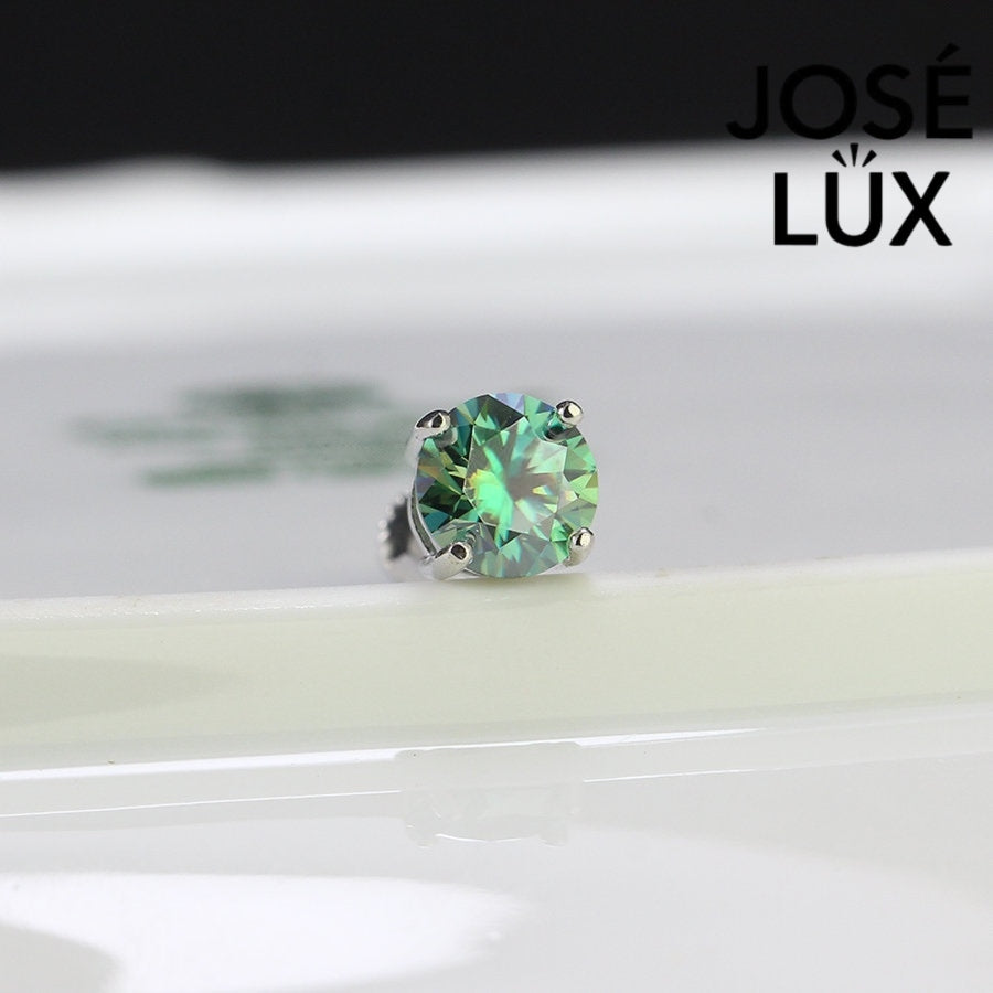 Green Moissanite Stud Earrings for Men - Sterling Silver (0.8ct) shown close-up with brilliant sparkle and four-prong setting on white surface.