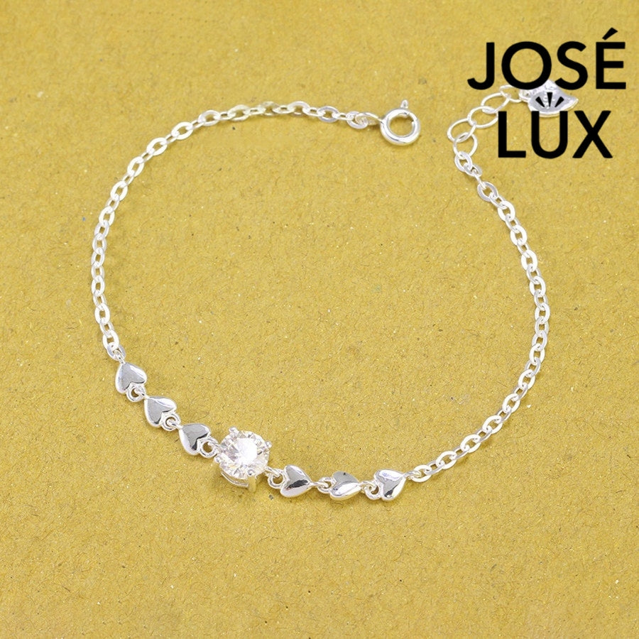 Heart chain solitaire moissanite bracelet in sterling silver showcases six romantic heart motifs with brilliant centerpiece stone weighing 0.8 carats on cable chain.
