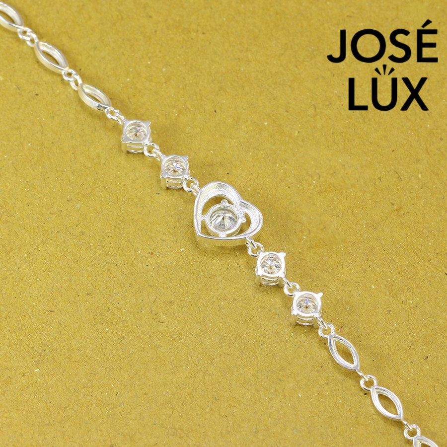 Heart motif moissanite bracelet crafted in sterling silver features five brilliant stones totaling 2.02 carats with elegant oval link chain design.