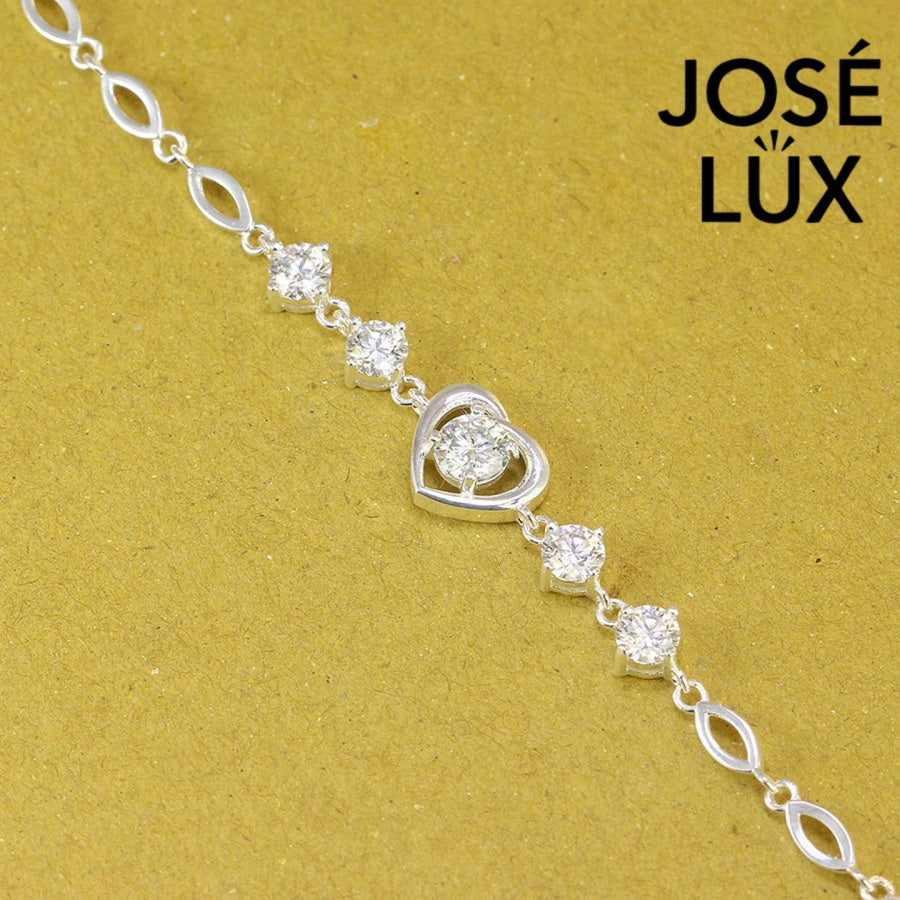 Heart motif moissanite bracelet crafted in sterling silver features five brilliant stones totaling 2.02 carats with elegant oval link chain design.