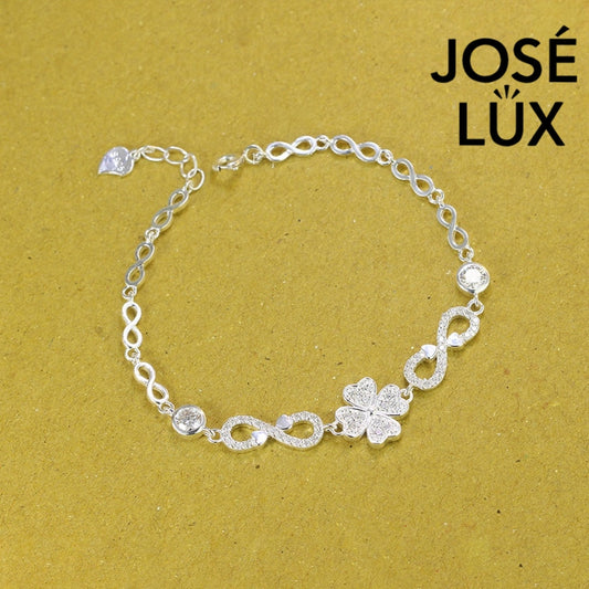 Infinity link moissanite bracelet in sterling silver showcases clover centerpiece with two brilliant stones totaling 0.68 carats on symbolic endless chain design.