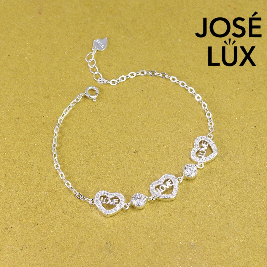 Love script heart station moissanite bracelet in sterling silver showcases three engraved heart charms with brilliant stones totaling 1.02 carats on cable chain.
